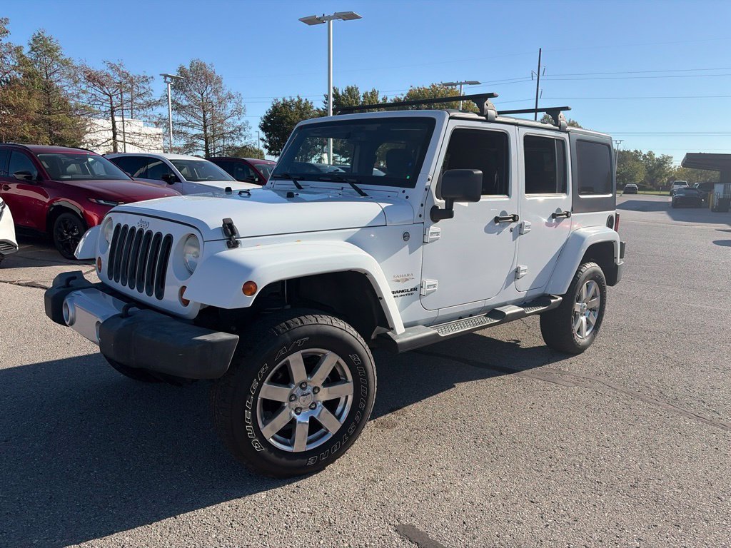 Used 2013 White Jeep Unlimited Sahara image 1