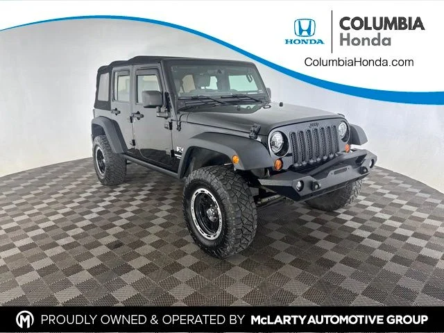 Used 2009 Black Jeep Unlimited X image 1
