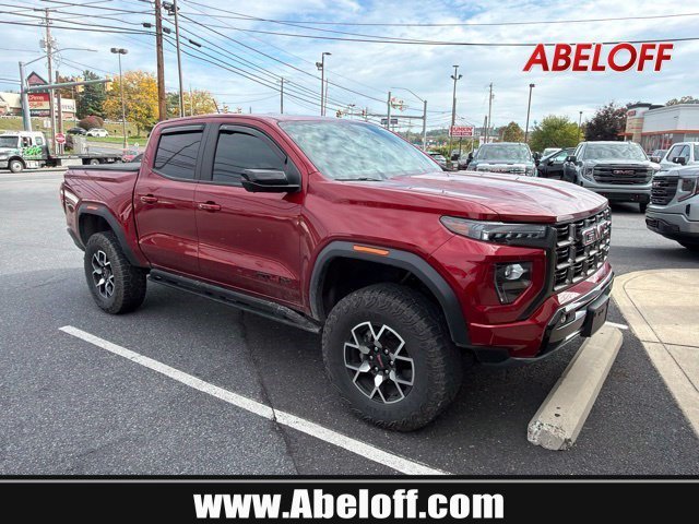 Used 2024 Volcanic Red Tintcoat GMC 4WD AT4X image 1