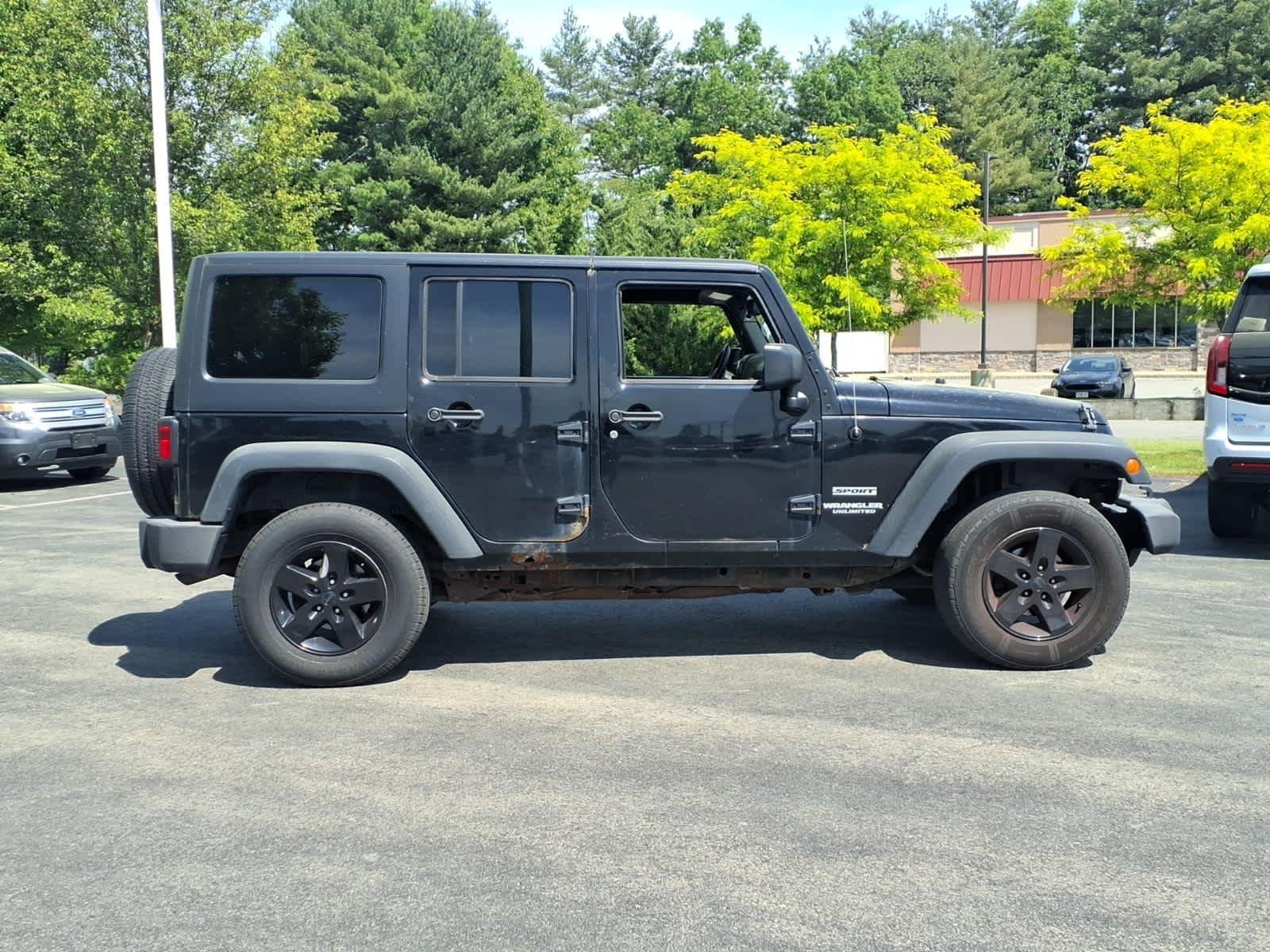 Used 2013 Black Clearcoat Jeep Sport image 3