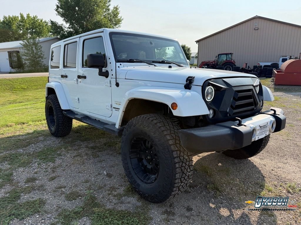 Used 2015 White Jeep Unlimited Sahara image 1