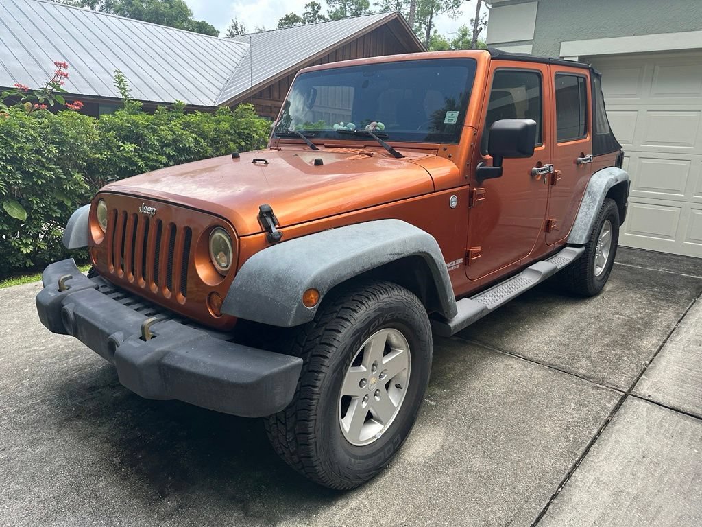 Used 2011 Mango Tango Pearl Jeep Sport image 1