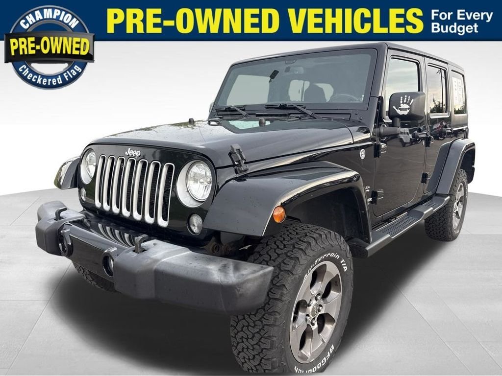 Used 2016 Black Jeep Unlimited Sahara image 1
