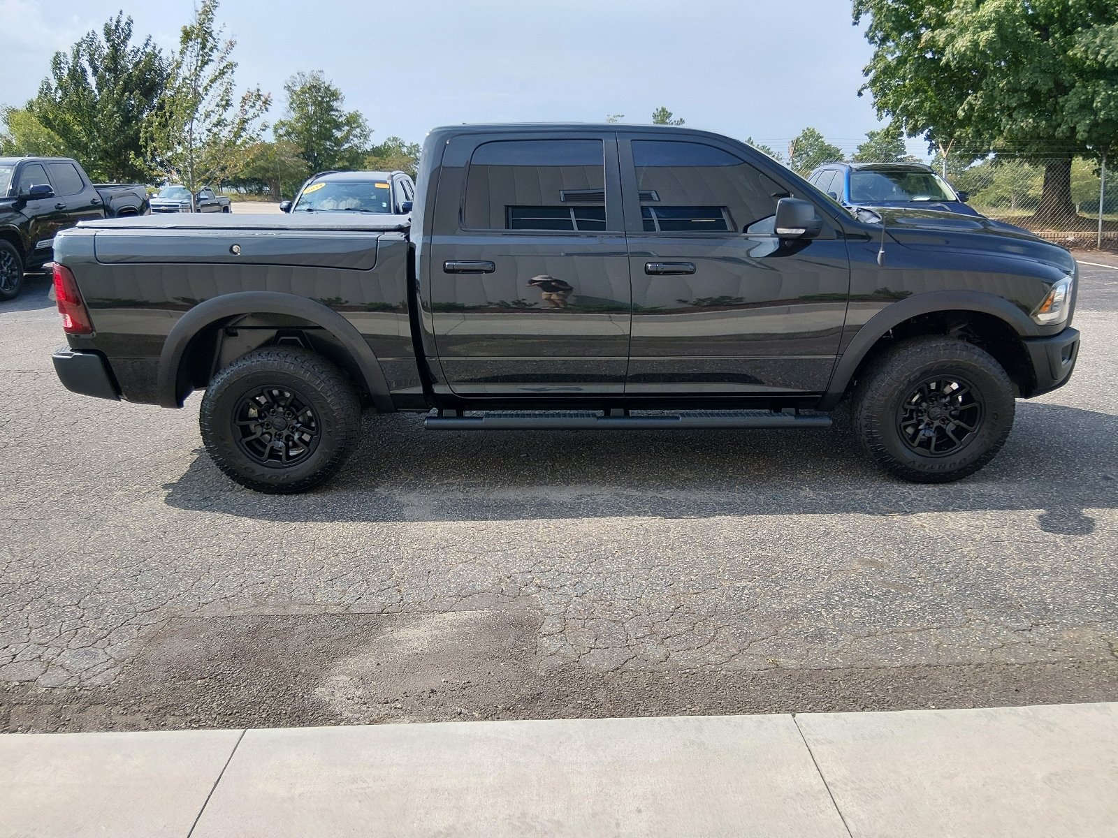 Used 2017 Brilliant Black Crystal Pearl Coat Ram 4x4 Rebel 4dr Crew Cab 5.5 ft. SB Pickup image 2