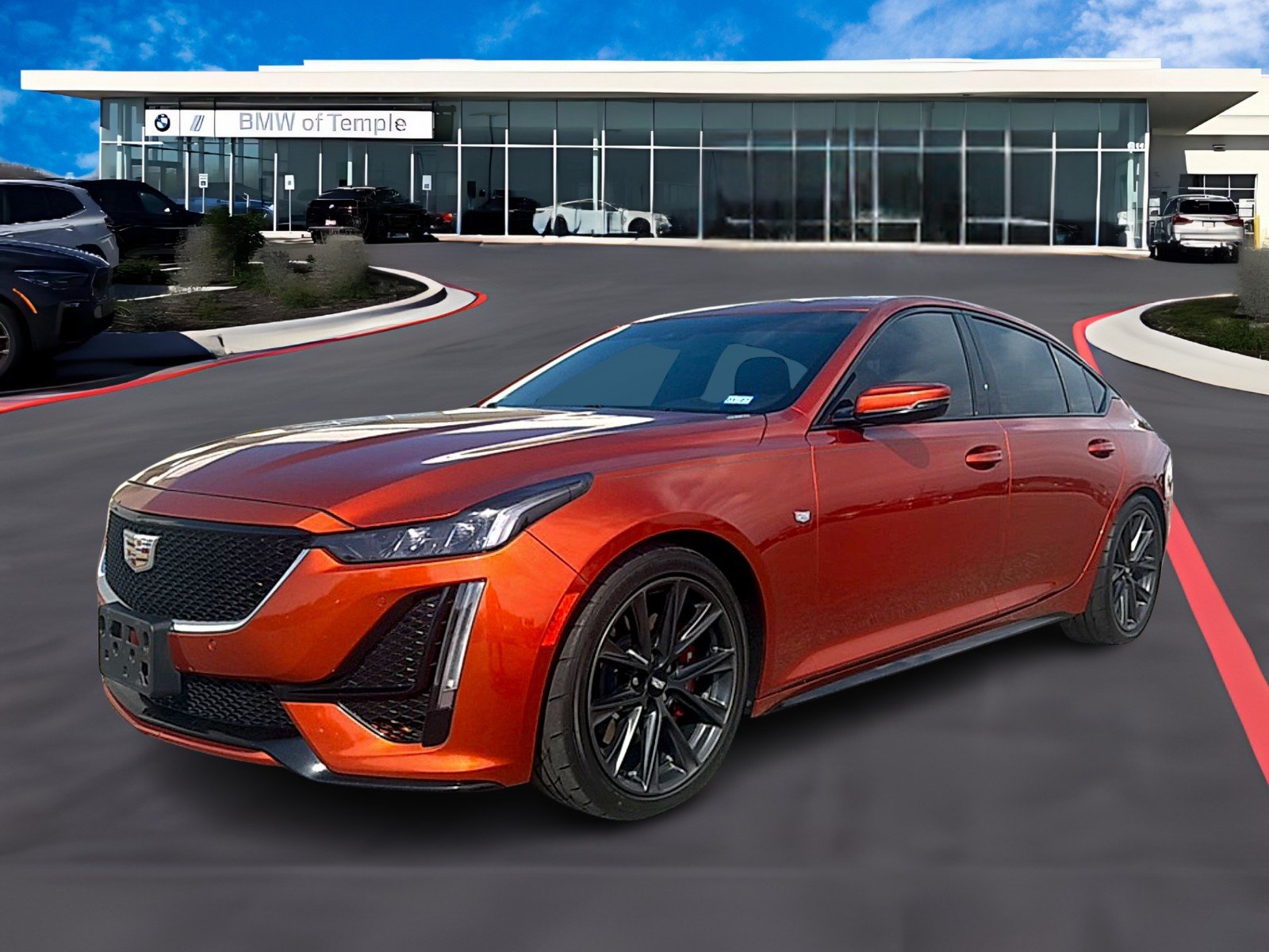 Used 2022 Blaze Orange Metallic Cadillac Sport image 1