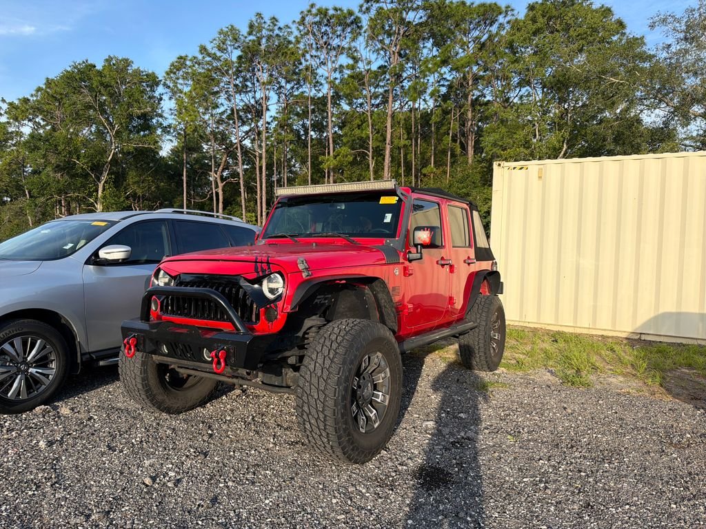 Used 2015 Red Jeep Unlimited Sport image 1