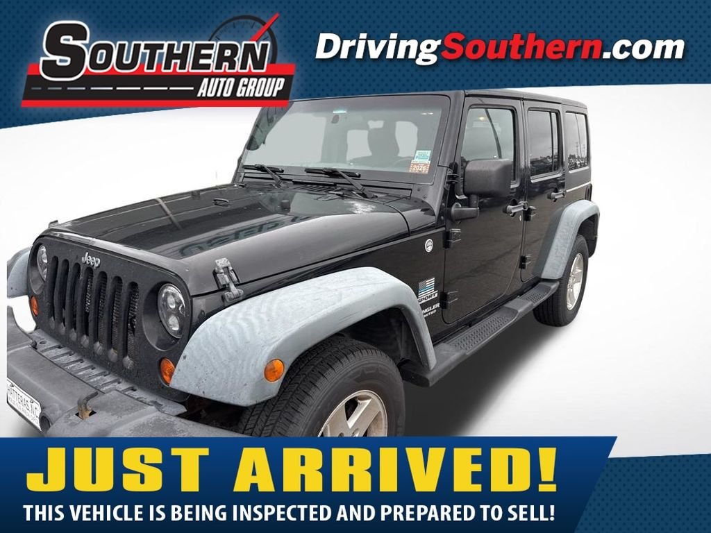 Used 2012 Black Jeep Unlimited Sport image 1