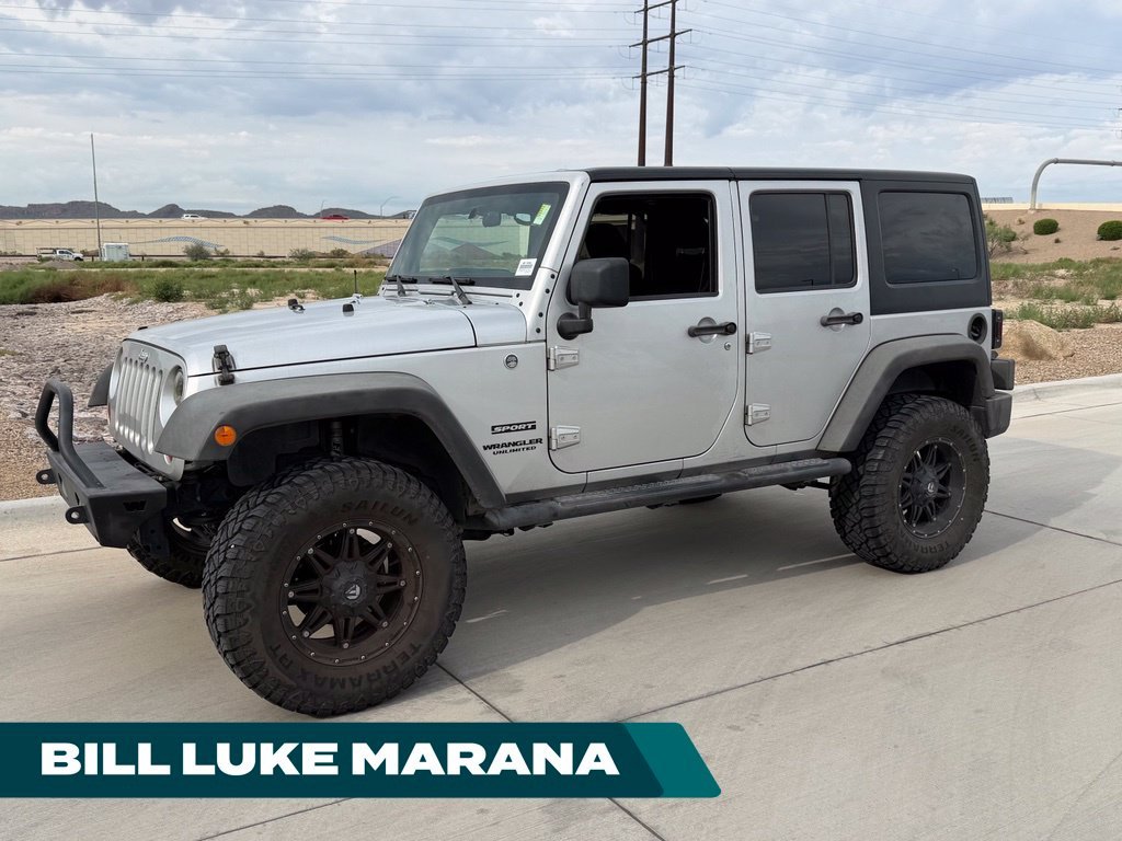 Used 2012 Silver Jeep Unlimited Sport S image 1