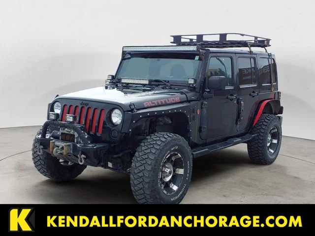 Used 2012 Black Jeep Unlimited Sahara Altitude image 1