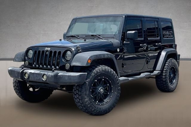 Used 2013 Black Jeep Unlimited Sport image 1
