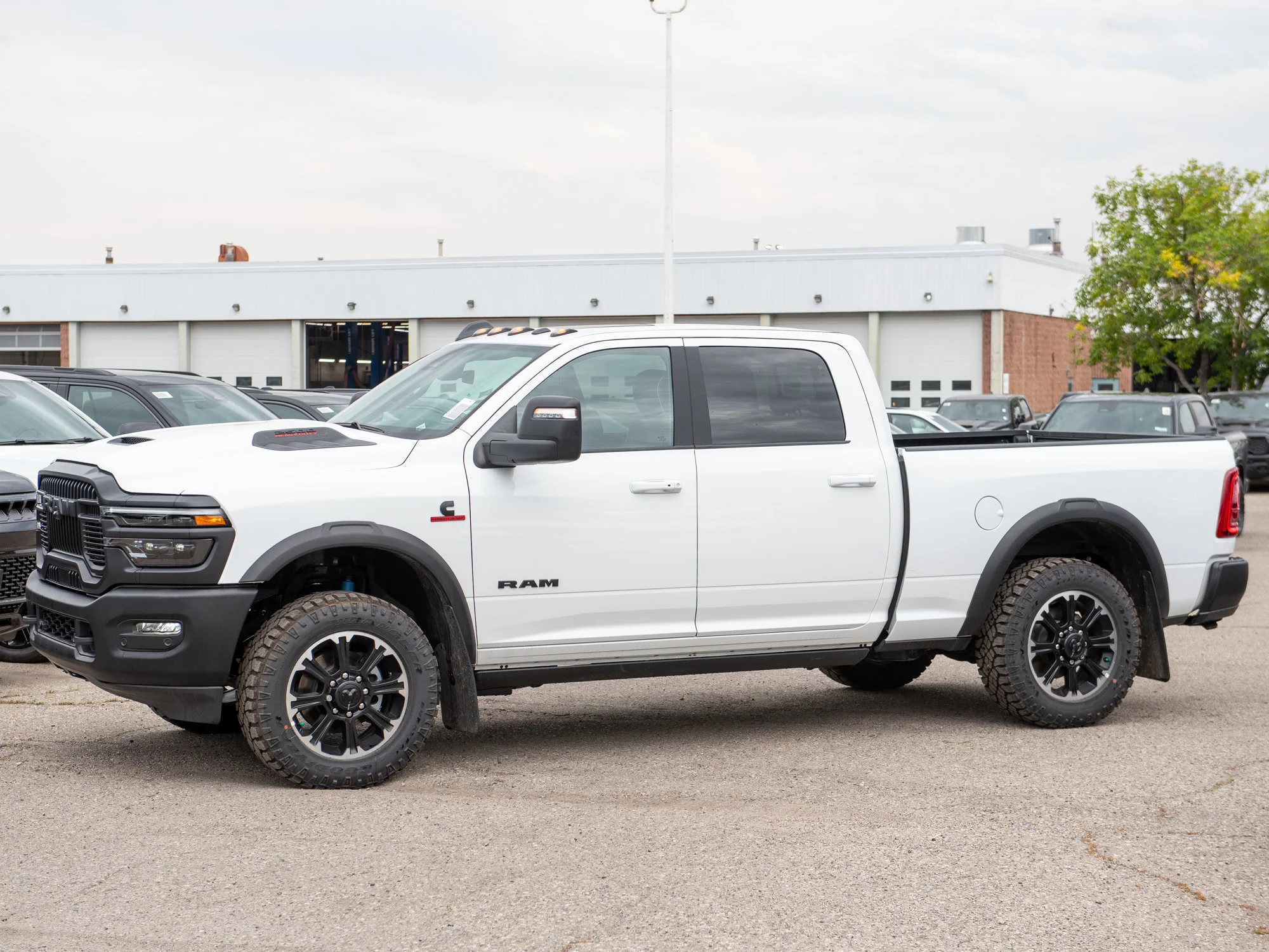 New 2026 White RAM Rebel* Crew Cab 4x4, 6.7L Cummins, Sunroof, 34 Inch A/T Tires, Passenger Screen image 4