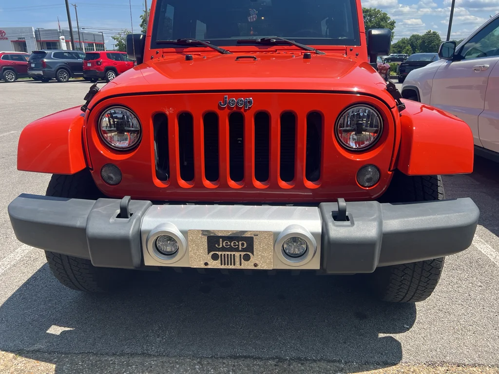 Used 2015 Sunset Orange Pearlcoat Jeep Sahara image 1