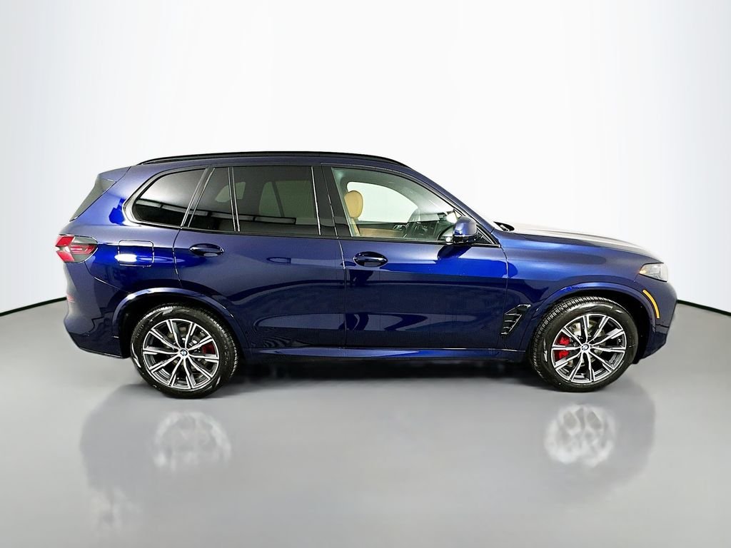 Used 2026 Tanzanite Blue II Metallic BMW xDrive50e image 4