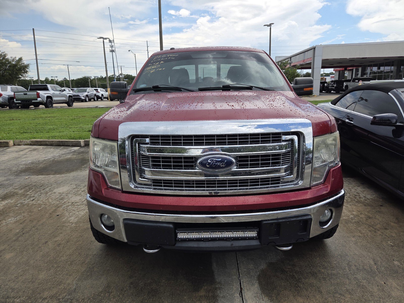 Used 2013 Ruby Red Metallic Ford XLT image 1