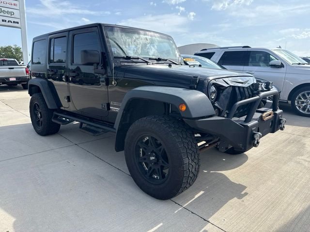 Used 2013 Black Jeep Unlimited Sport image 1