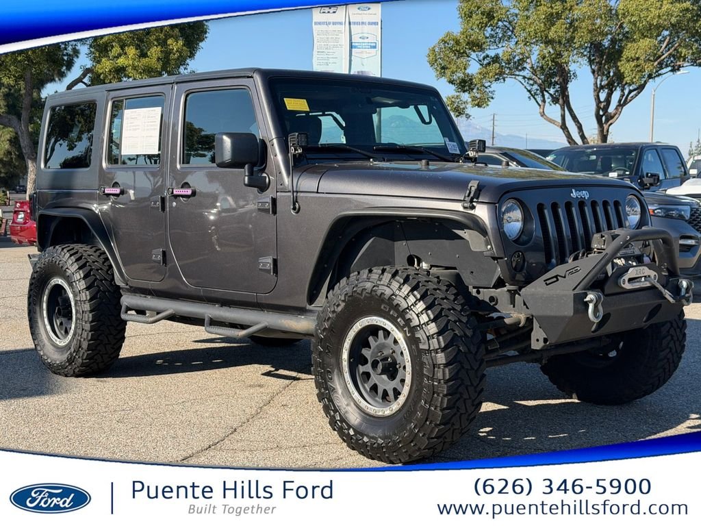 Used 2016 Granite Crystal Clearcoat Metallic Jeep Unlimited Sport image 1