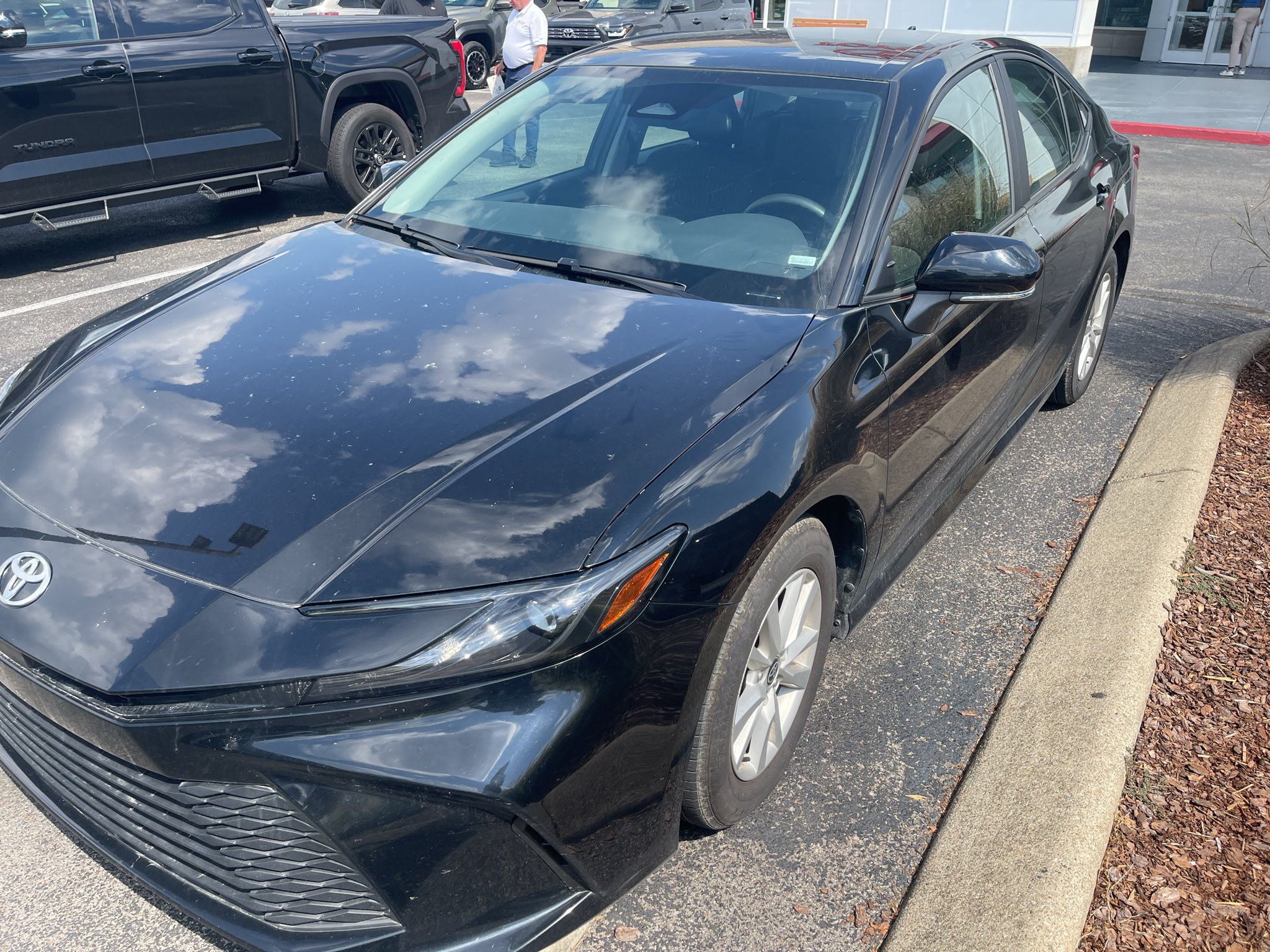 Used 2025 Midnight Black Metallic Toyota LE image 1