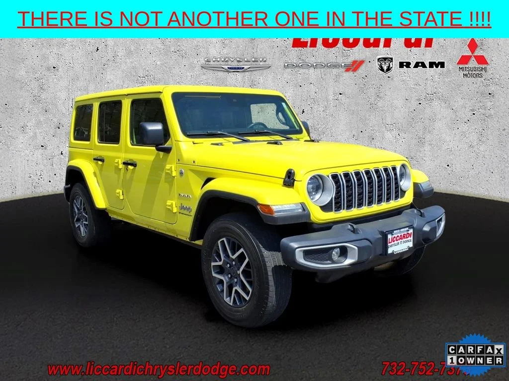 Used 2024 Yellow Jeep Sahara image 1