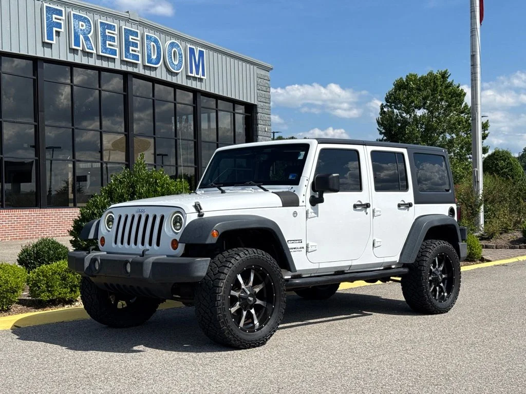 Used 2013 Bright White Jeep Unlimited Sport image 1