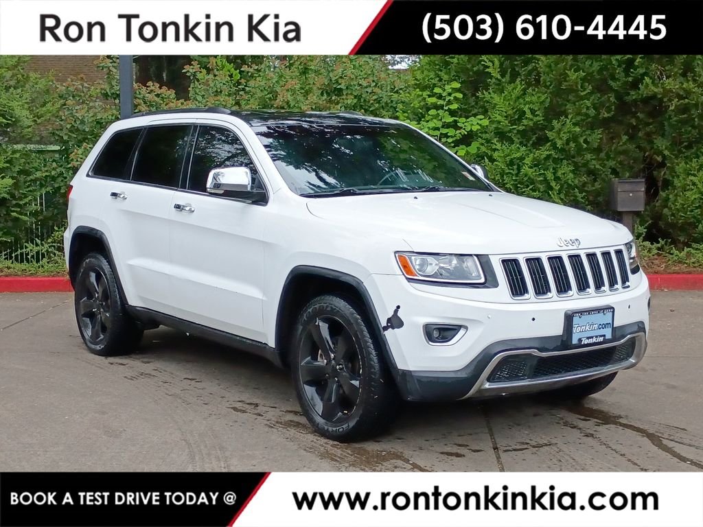 Used 2014 Black Forest Green Pearlcoat Jeep Limited image 1