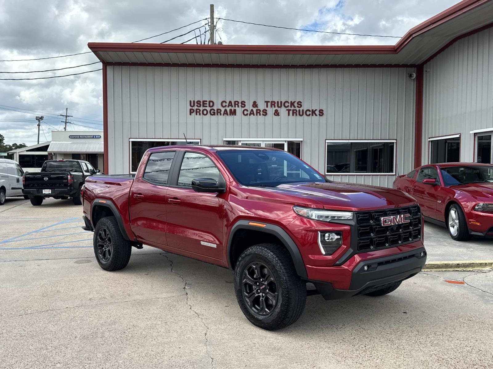 Used 2025 Volcanic Red Tintcoat GMC 2WD Elevation image 1