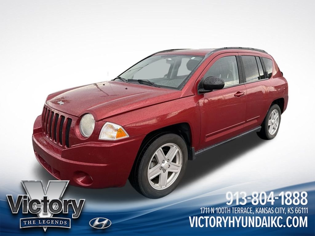 Used 2010 Red Jeep Sport image 1
