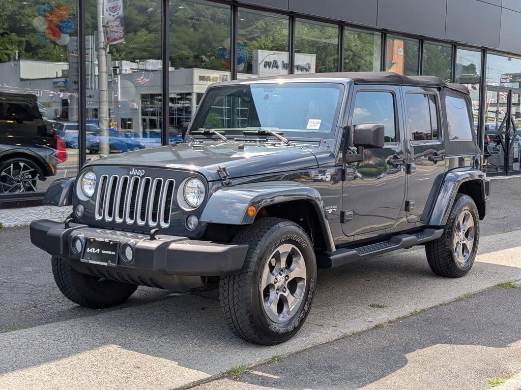 Used 2016 Black Jeep Unlimited Sahara image 1
