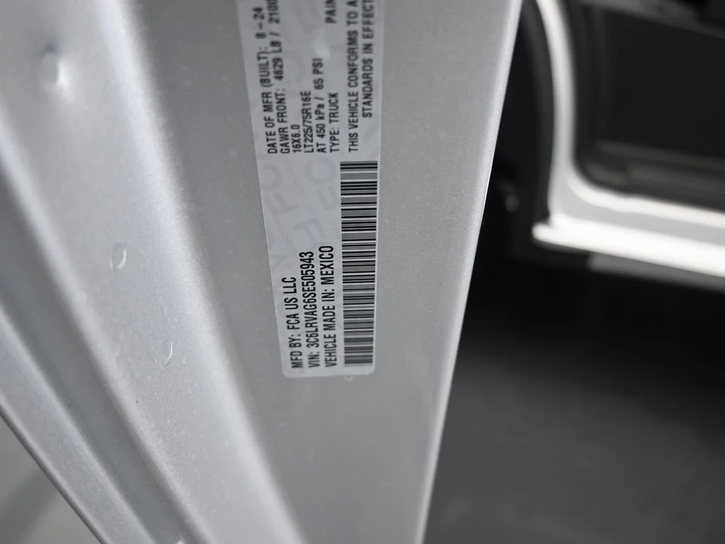 Used 2025 Bright Silver Clearcoat Metallic Ram Low Roof image 14