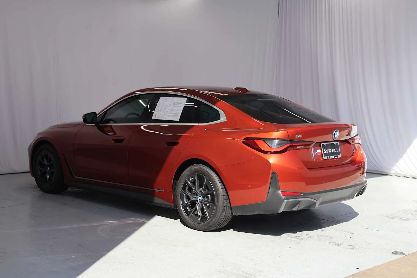 Certified Used 2023 Sunset Orange Metallic BMW eDrive40 image 4