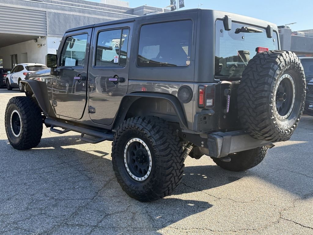 Used 2016 Granite Crystal Clearcoat Metallic Jeep Unlimited Sport image 4