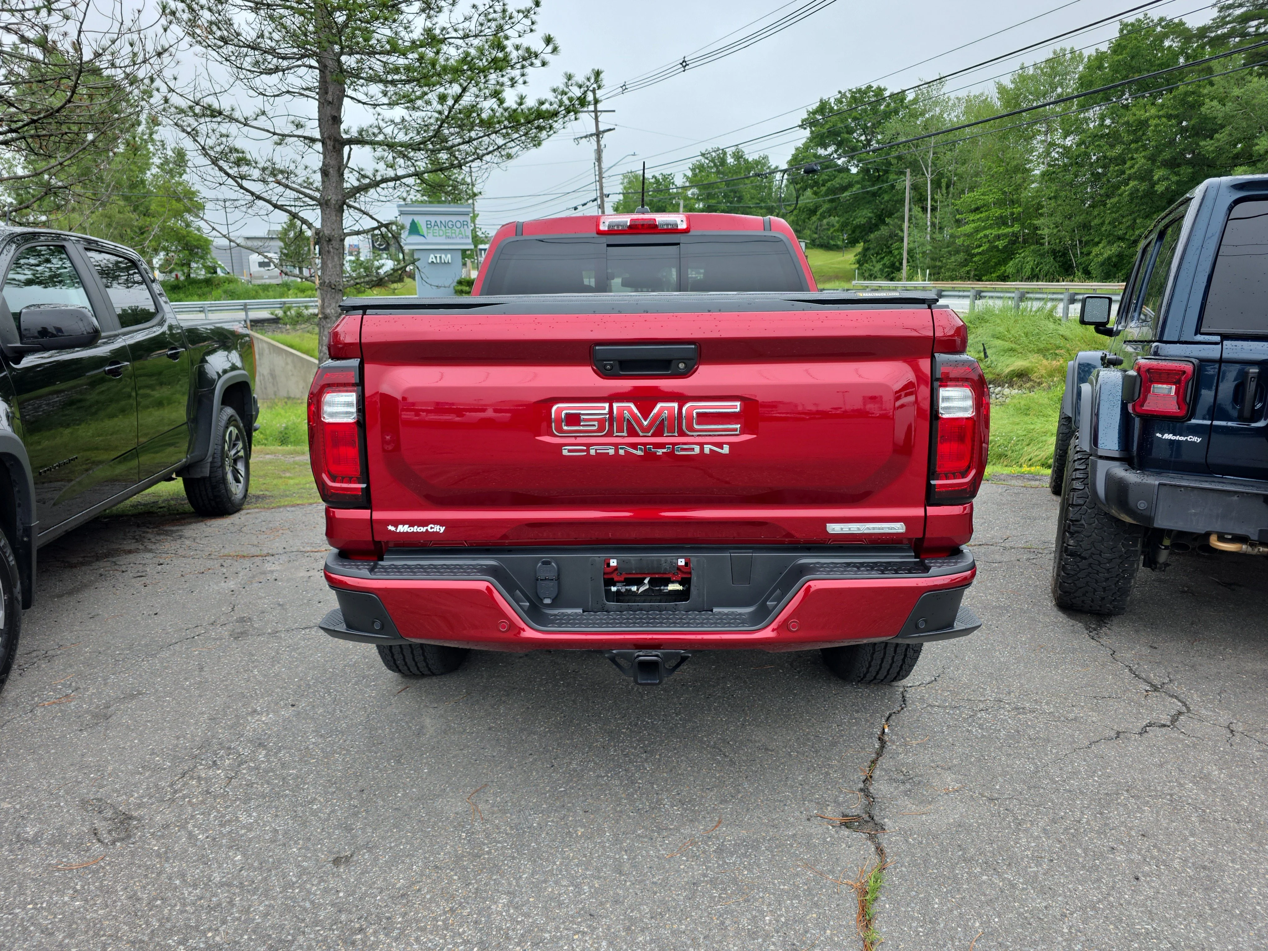 Used 2024 Volcanic Red Tintcoat GMC 4WD Elevation image 3