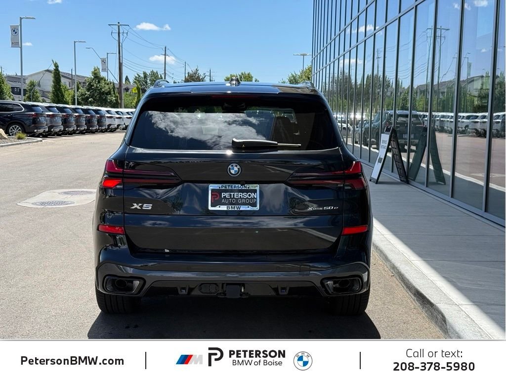 New 2026 Black Sapphire Metallic BMW xDrive50e image 4