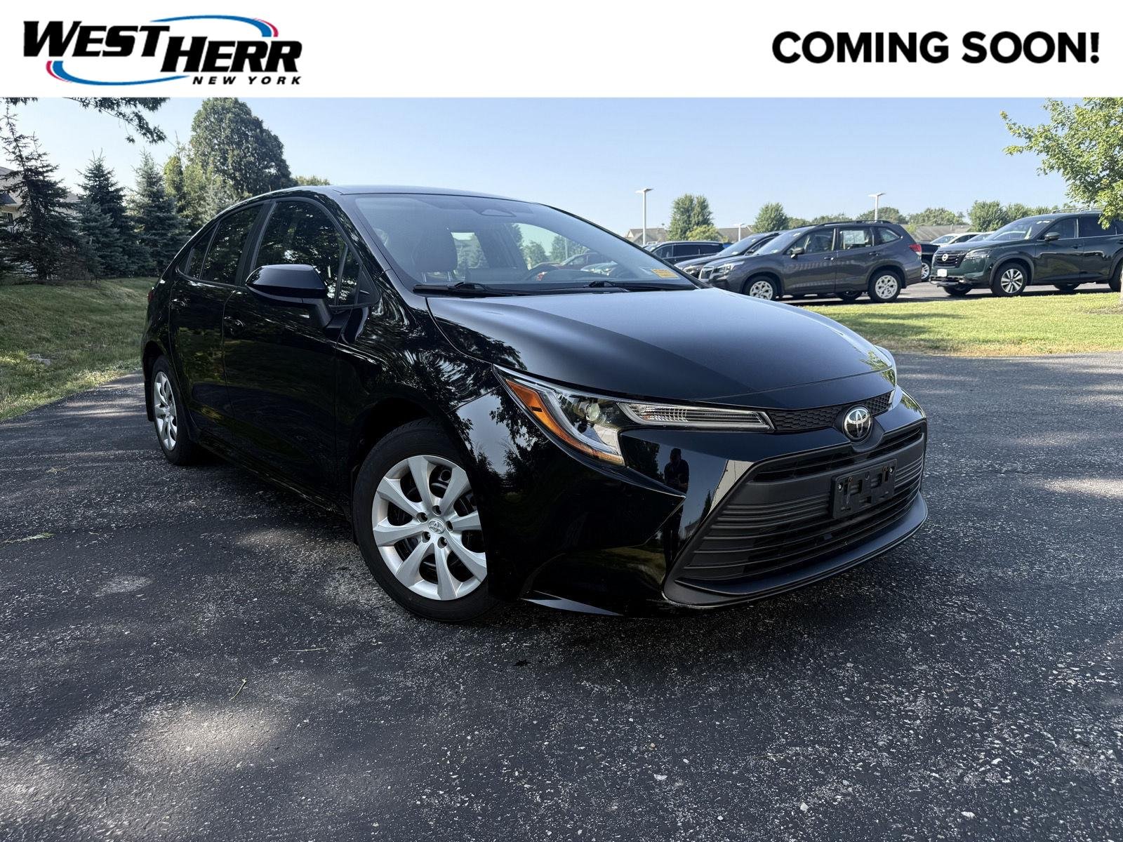 Used 2023 Midnight Black Metallic Toyota LE image 1