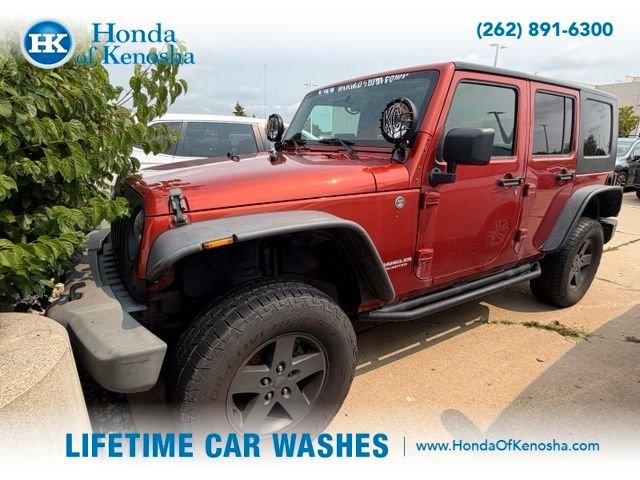 Used 2009 Sunburst Orange Pearl Jeep Unlimited X image 1