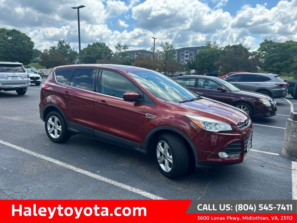 Used 2015 Orange Ford SE image 1