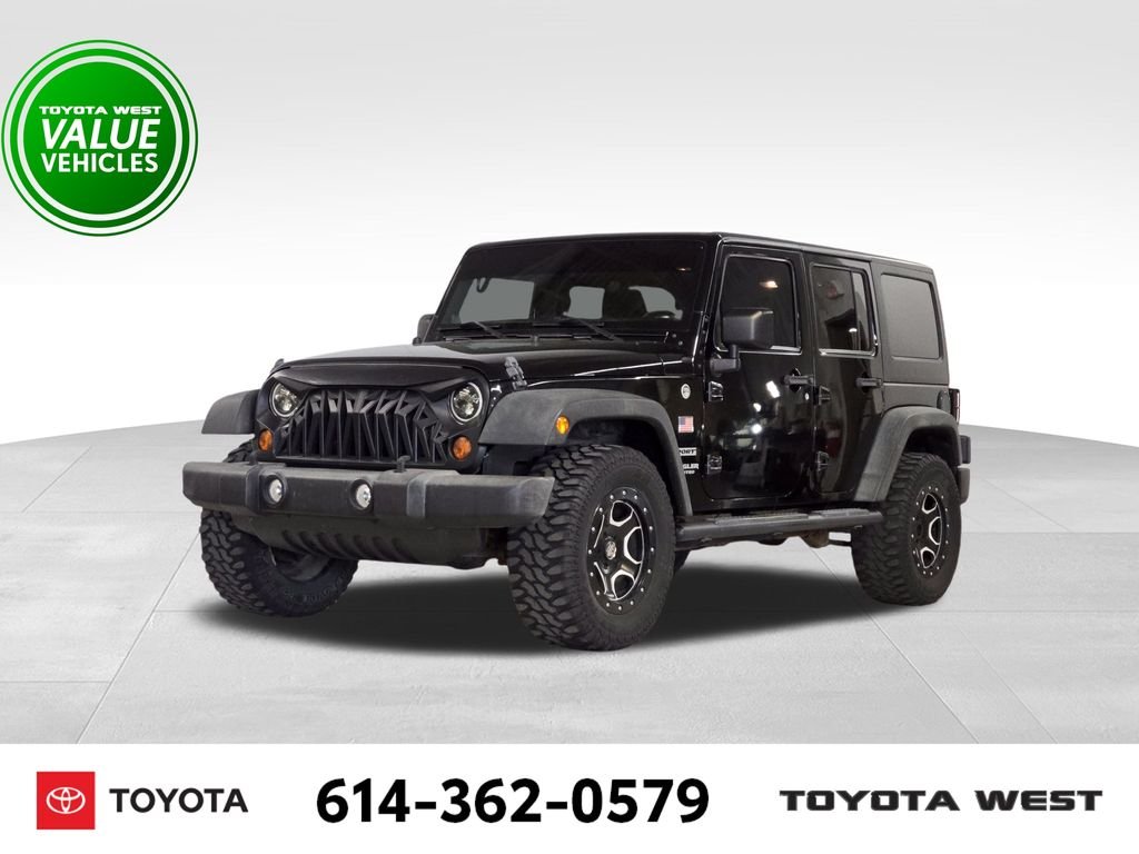 Used 2013 Black Jeep Unlimited Sport image 1