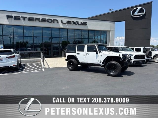Used 2013 White Jeep Unlimited Sport image 1