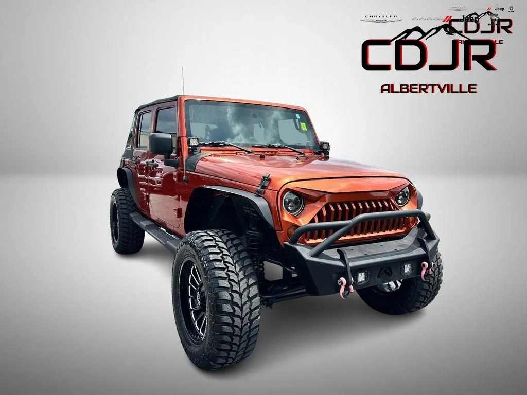 Used 2009 Orange Jeep Unlimited X image 1