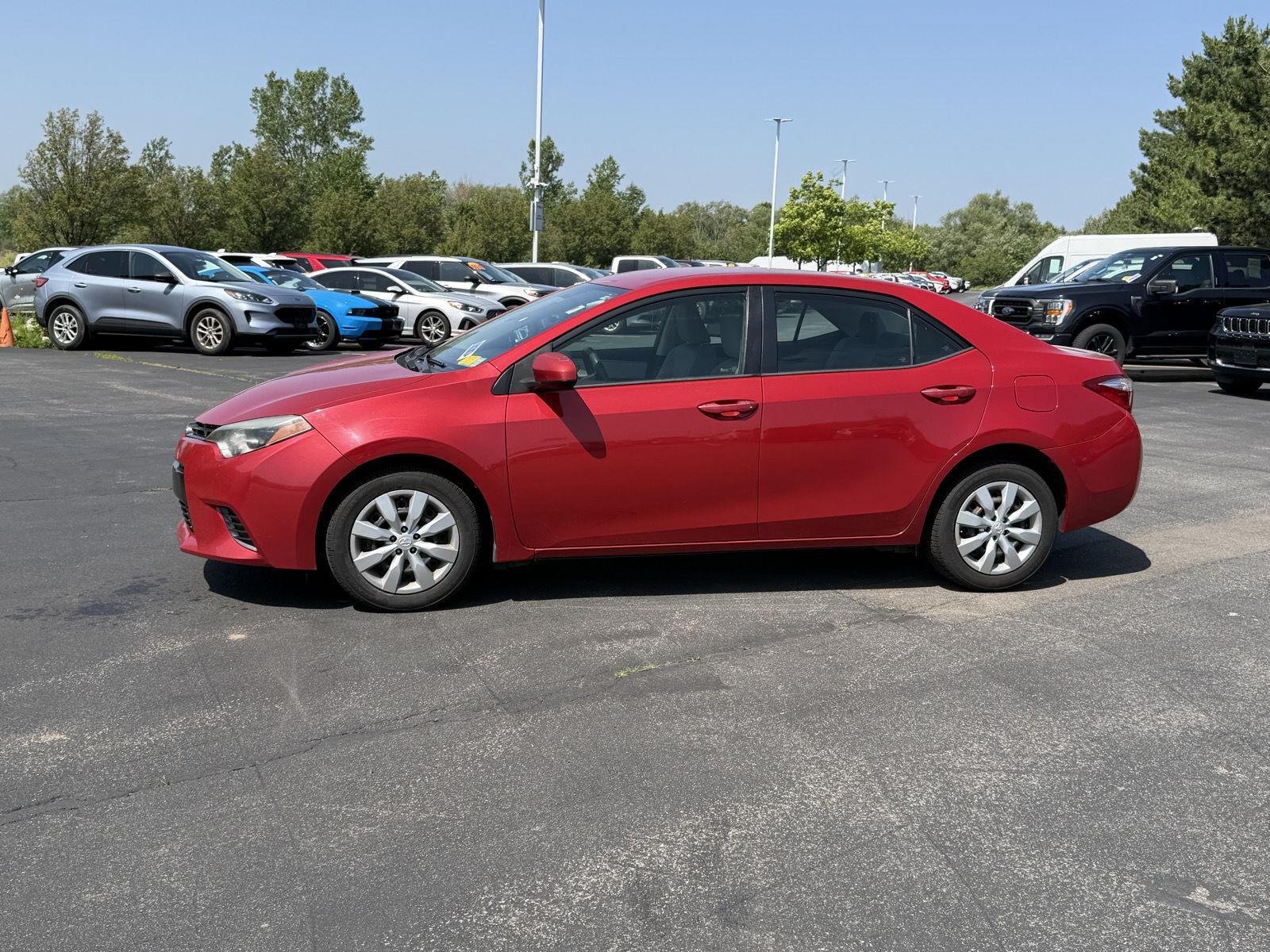 Used 2015 Barcelona Red Metallic Toyota LE image 4