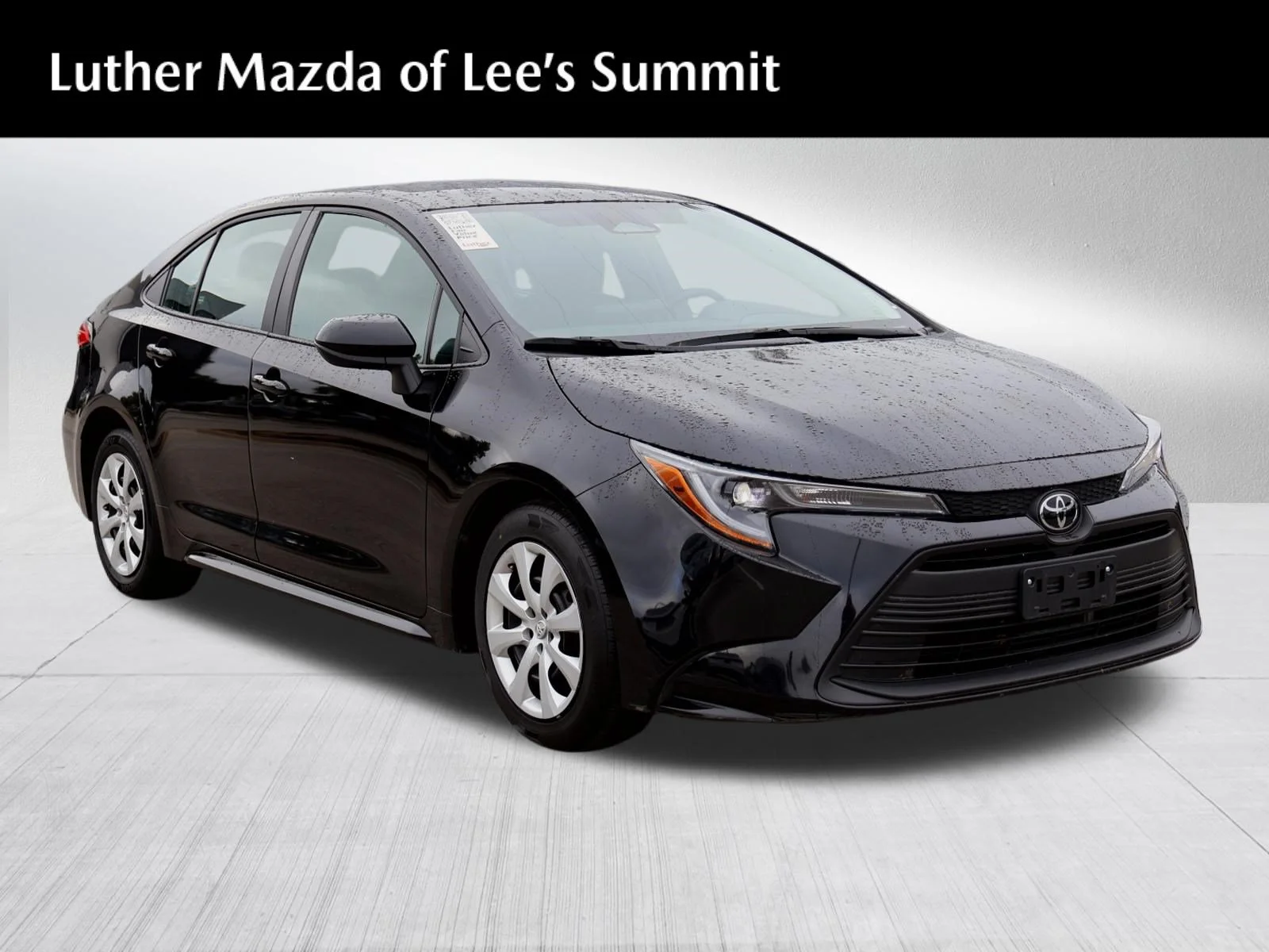 Used 2025 Midnight Black Metallic Toyota LE image 1