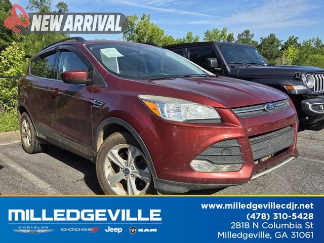 Used 2014 Orange Ford SE image 1