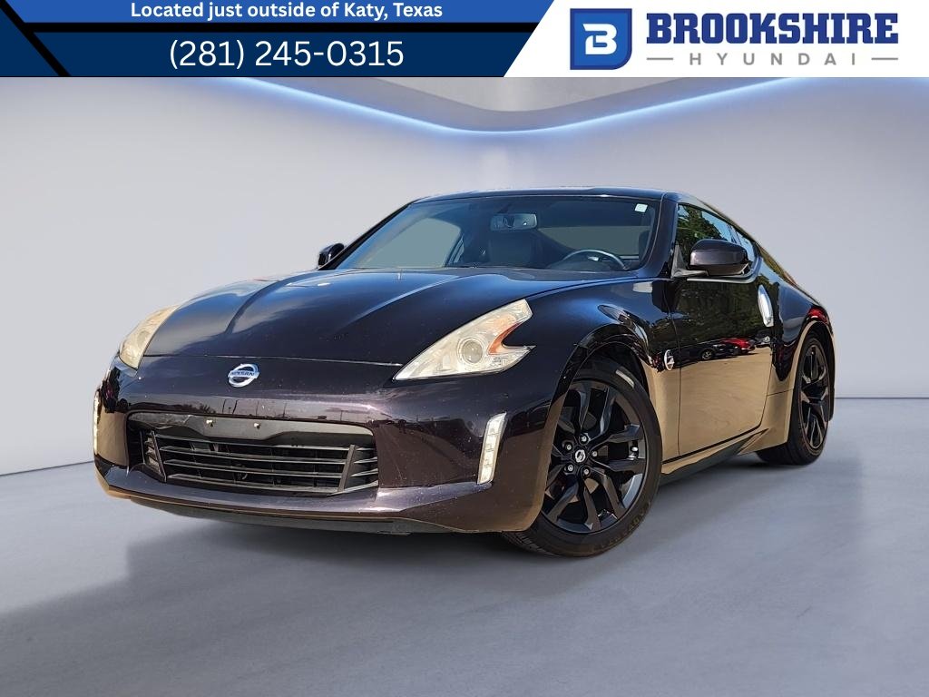Used 2016 Black Cherry Nissan Touring image 1