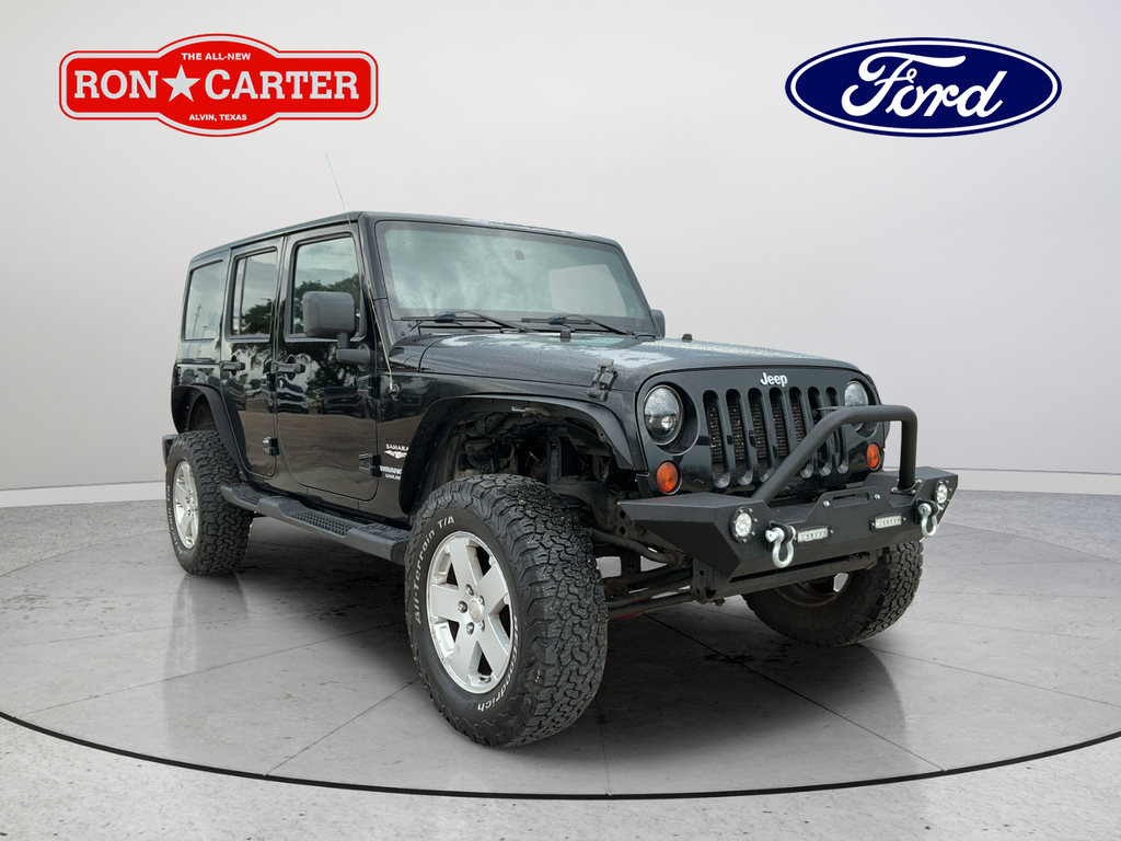 Used 2012 Black Clearcoat Jeep Unlimited Sahara image 1