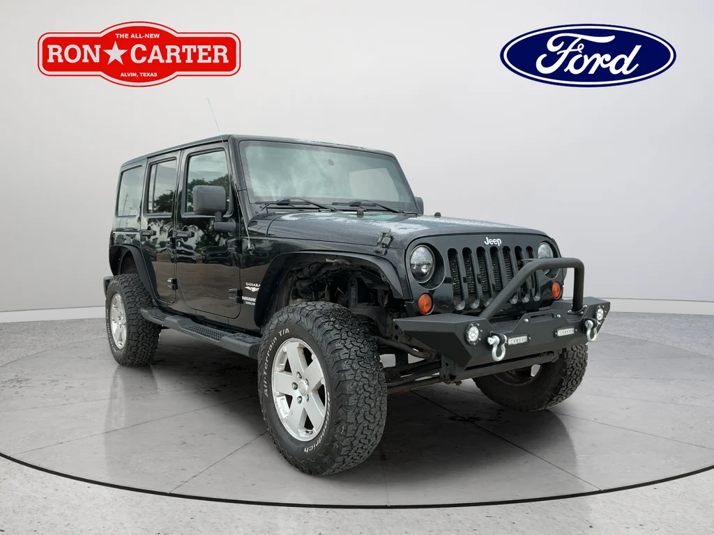 Used 2012 Black Jeep Unlimited Sahara image 1