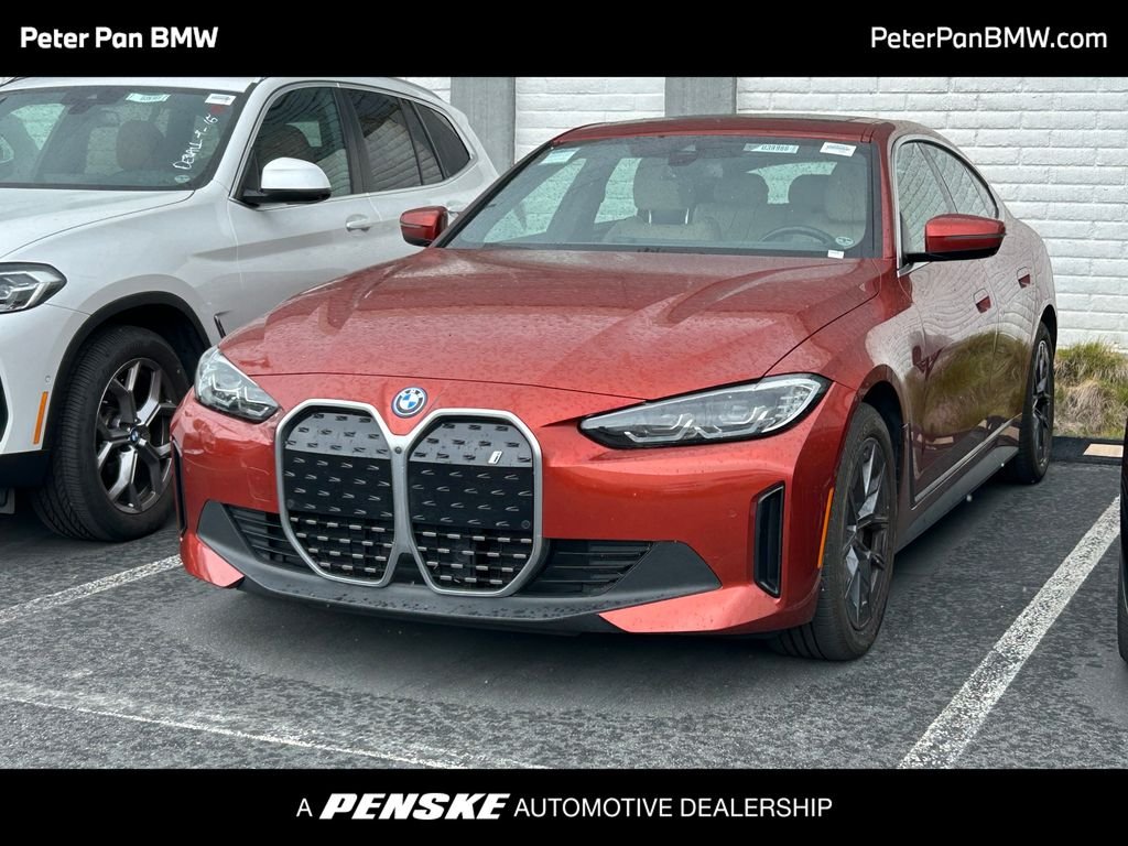 Certified Used 2023 Sunset Orange Metallic BMW eDrive40 image 1