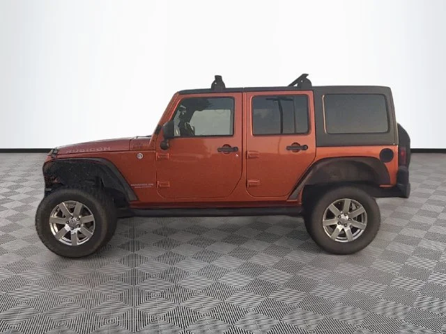 Used 2011 Orange Jeep Unlimited Rubicon image 1