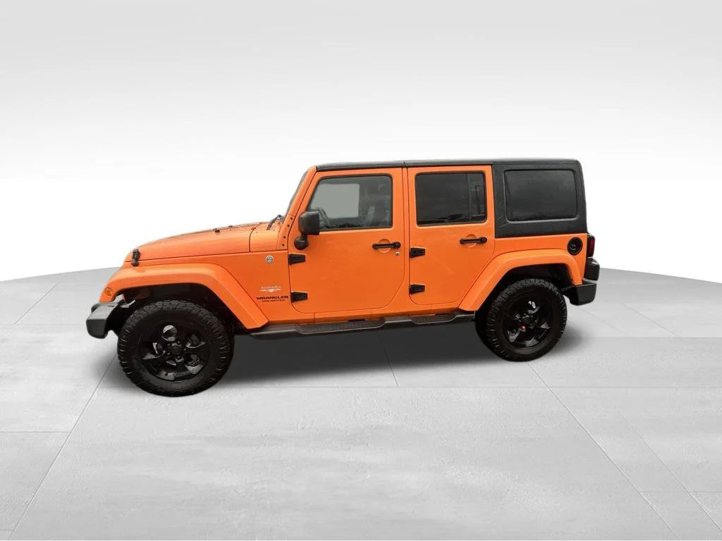 Used 2013 Orange Jeep Unlimited Sahara image 4