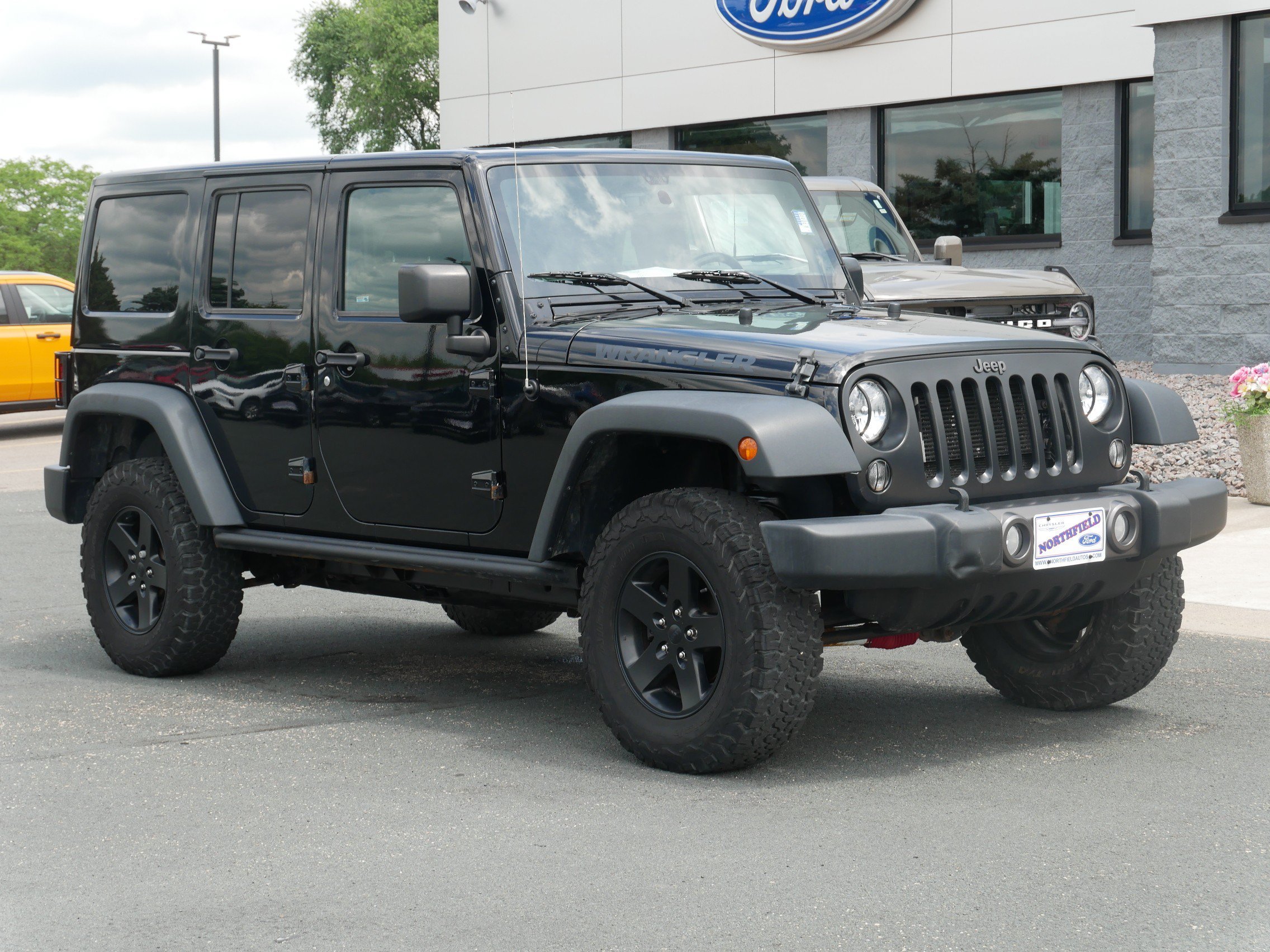 Used 2016 Jeep Wrangler Unlimited Black Bear with VIN 1C4BJWDG6GL135878 for sale in Northfield, Minnesota