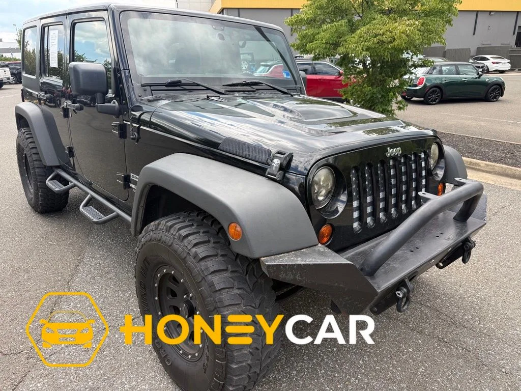Used 2011 Black Jeep Unlimited Sport image 1