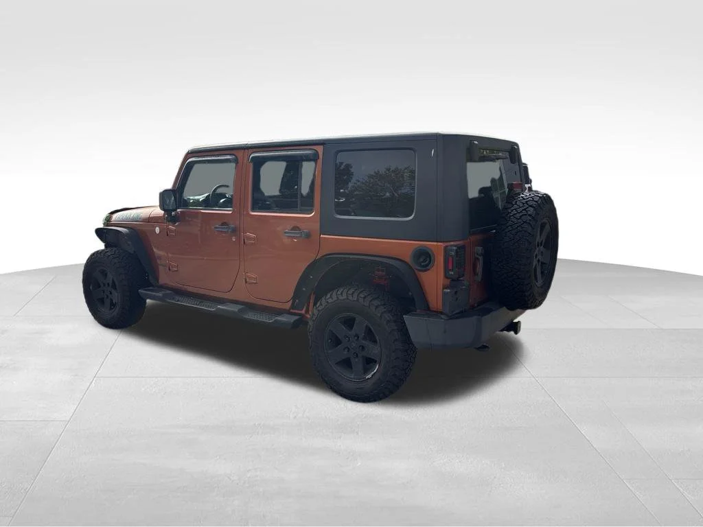 Used 2010 Orange Jeep Unlimited Sport image 7